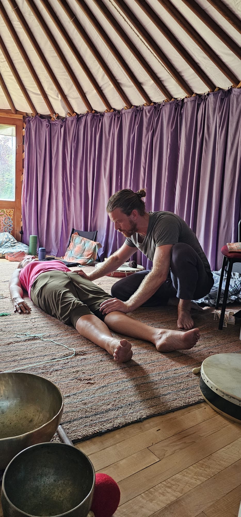 A bodywork treatment inside a yurt with singing bowls