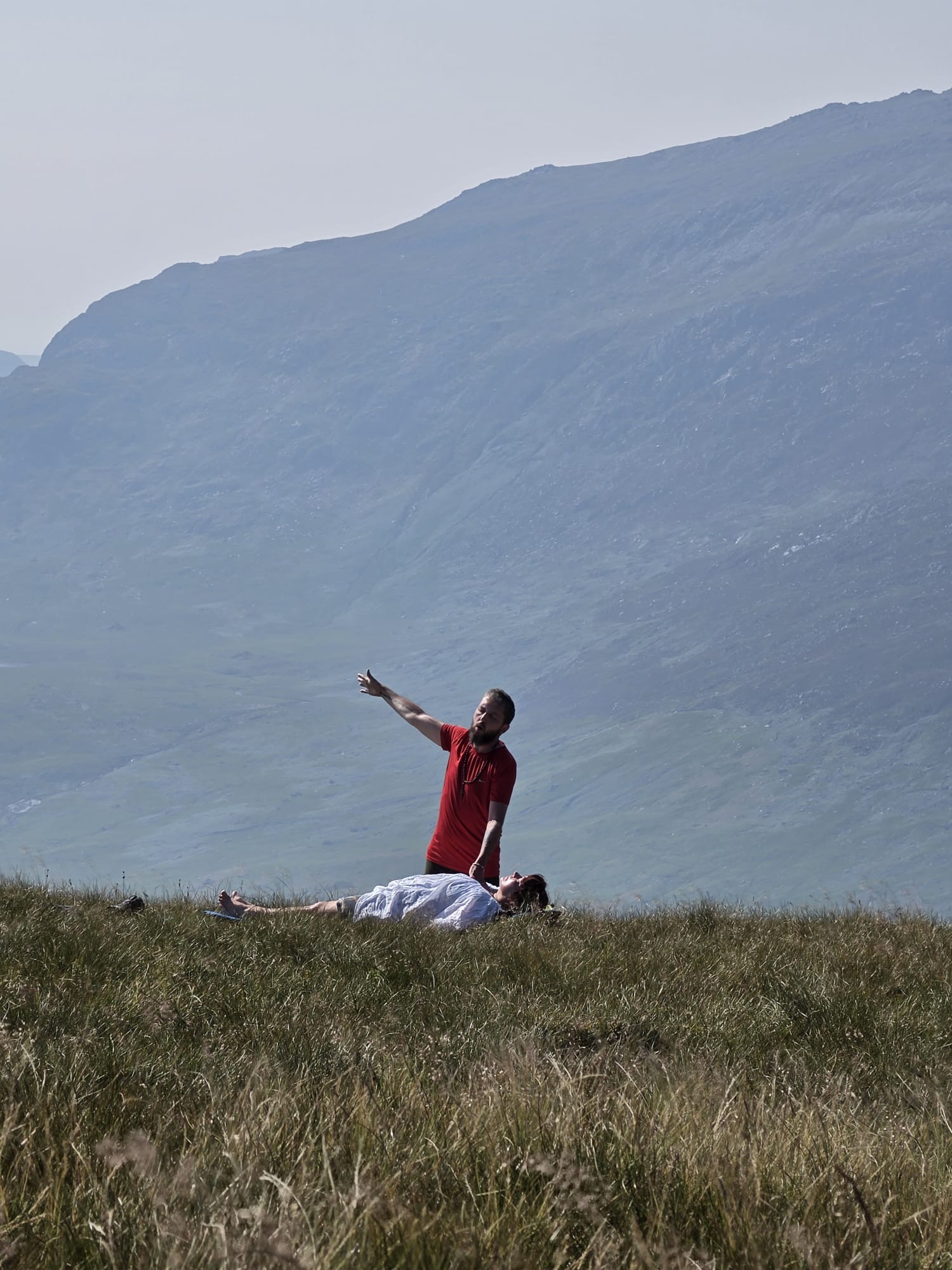 An outdoor healing session on a mountainside